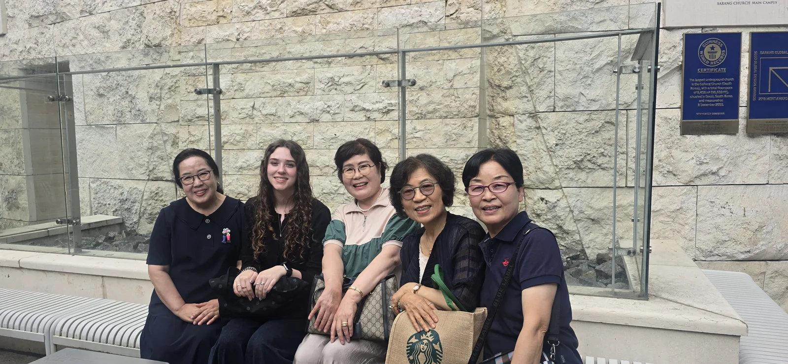 Teachers and a student together on the stone steps