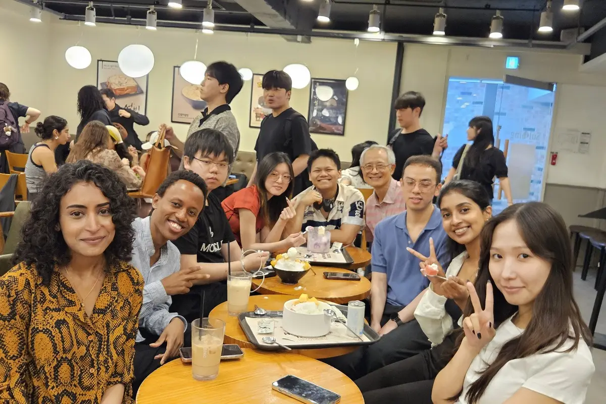 ISC-Sogang friends gathered around café tables, laughing together